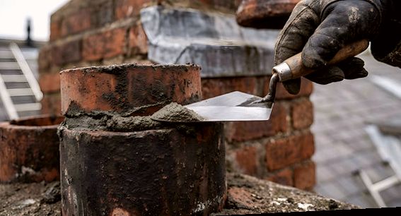 Fresh mortar worked around a clay pot on a Glendora chimney